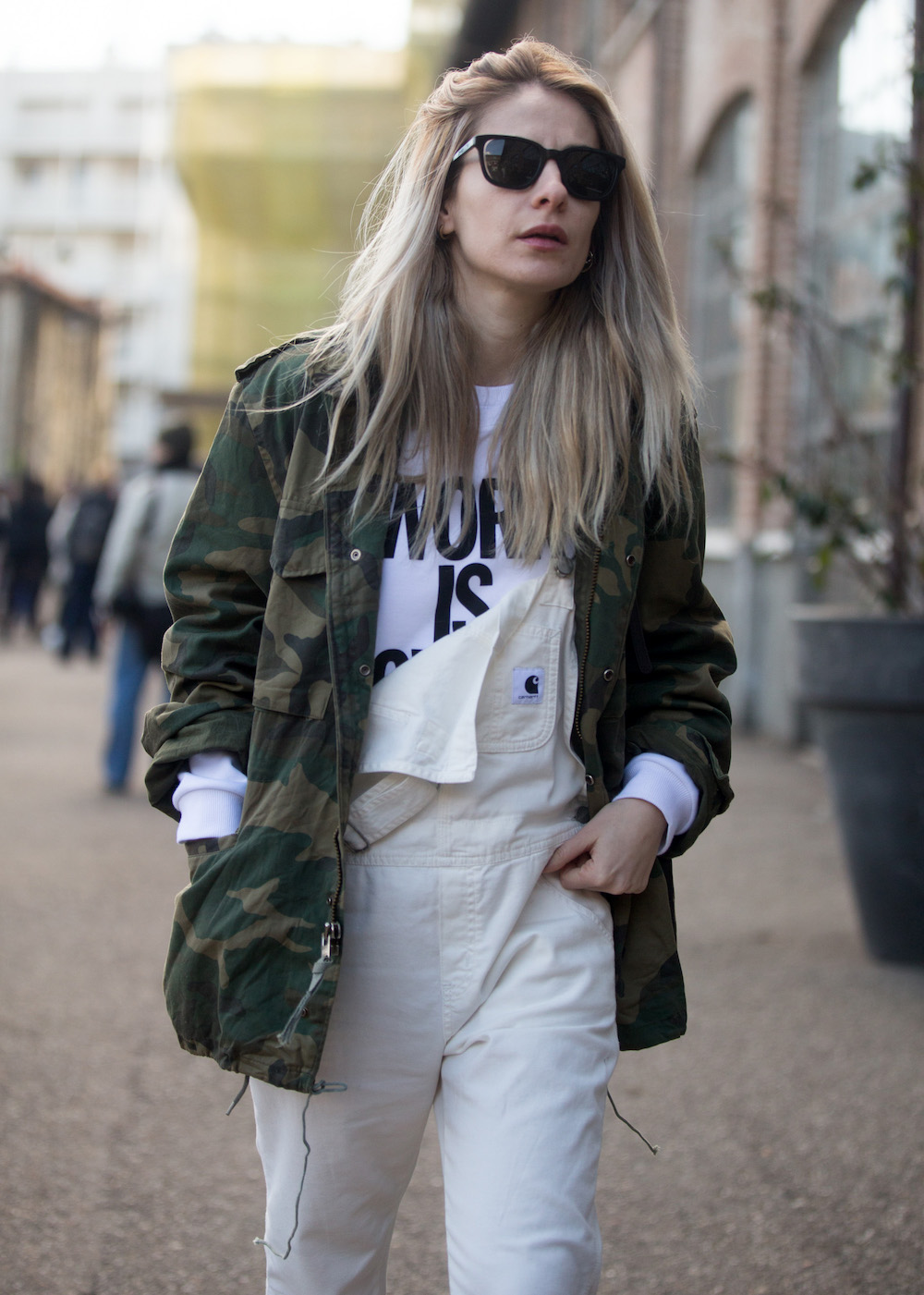 A guest wears a camoflauge jacket and white overalls
