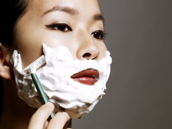 young Asian woman shaving