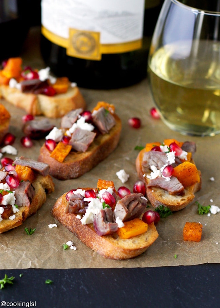 STYLECASTER | 25 Festive Recipes That Will Impress Your Friends on New Year’s Eve | Roasted Butternut Squash, Steak, and Pomegranate Crostini