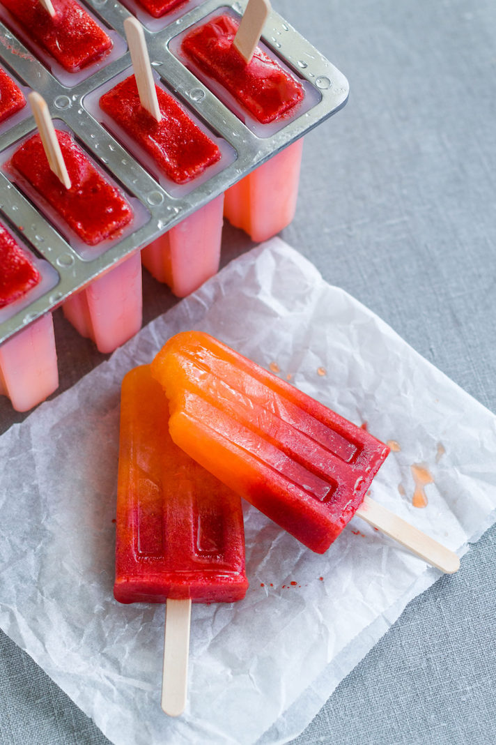 STYLECASTER | 17 DIY Popsicles To Make With All That Summer Fruit | Orange-Strawberry Sunrise Popsicles