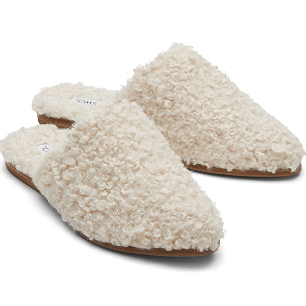 A pair of pointed-toe mules lined with white bouclé fabric