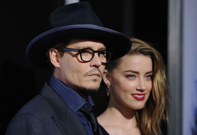 Johnny Depp and actress Amber Heard arrive at the Los Angeles premiere of '3 Days to Kill' at ArcLight Cinemas on February 12, 2014 in Hollywood, California.