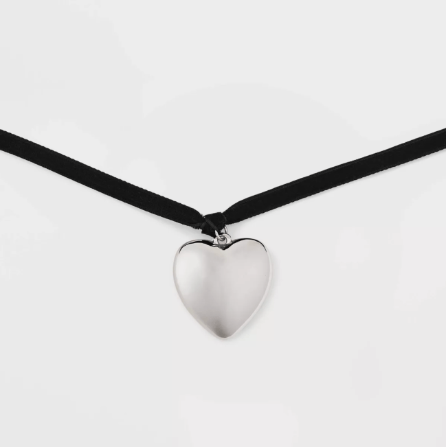 A black rope choker necklace with a puffy silver heart pendant from Target