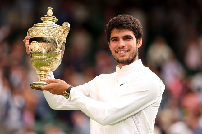 Carlos Alcaraz of Spain with the Men's Singles Trophy following his victory in the Men's Singles Final against Novak Djokovic of Serbia on day fourteen of The Championships Wimbledon 2023 at All England Lawn Tennis and Croquet Club on July 16, 2023 in London, England