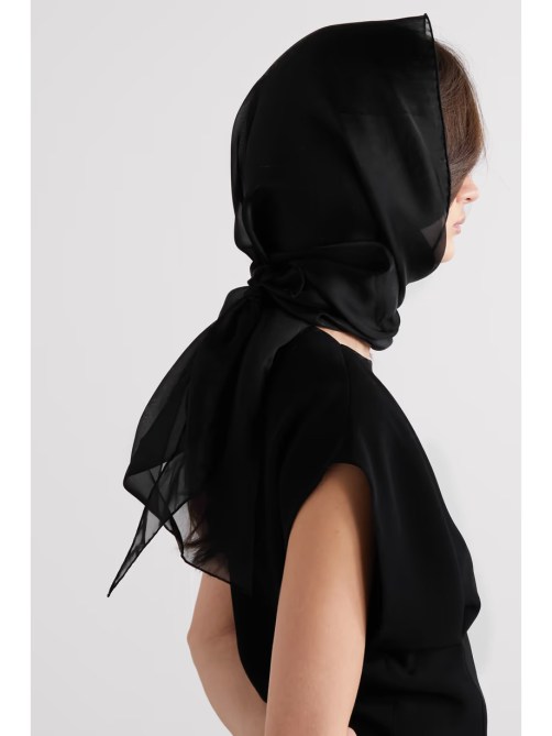 Model wears silk organza scarf over her head.