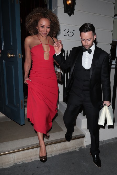 Mel B leaving Victoria Beckham's party wearing a red dress.