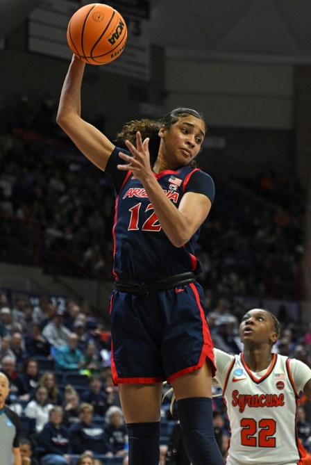 STORRS, CONNECTICUT - MARCH 23: Esmery Martinez #12 of the University of Arizona Wildcats grabs a rebound over Kyra Wood #22 of the Syracuse University Orange during the first round of the 2024 NCAA Women's Basketball Tournament held at Harry A. Gampel Pavilion on March 23, 2024 in Storrs, Connecticut.