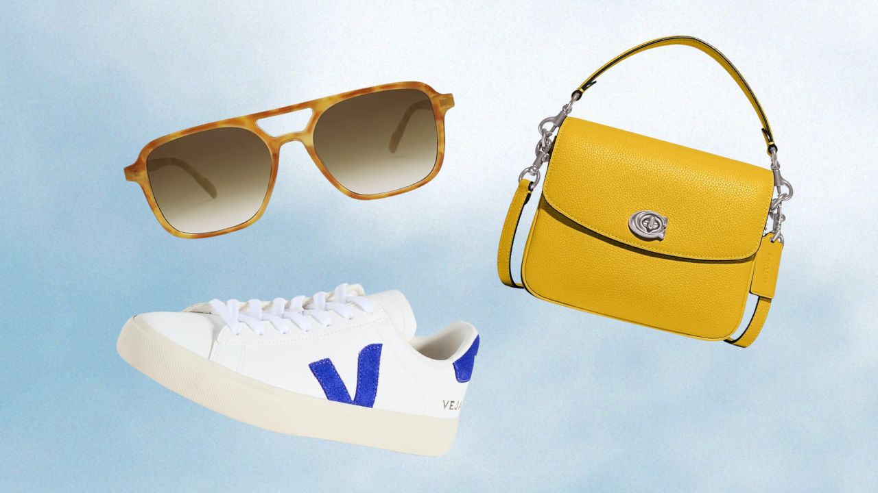 From left to right: White Veja sneakers with a blue logo, retro aviator sunglasses, yellow coach bag
