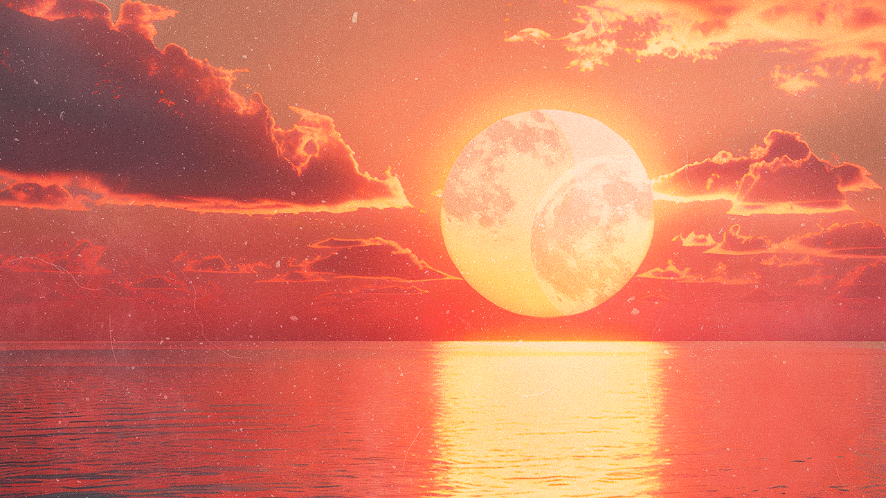 Two full moons within a glowing sun hanging over an ocean at sunset during summer