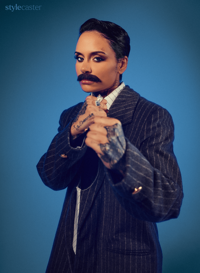 Kehlani in a fighting stance wearing a suit