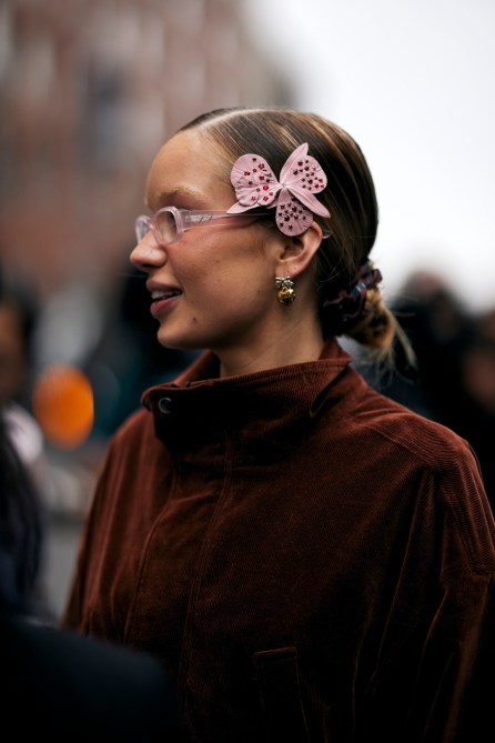 A fashion week guest wearing Sandy Liang heart earrings.