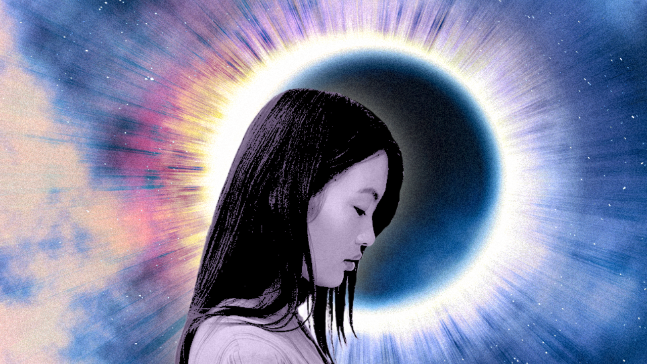 A woman's profile in front of a solar eclipse with a burst of light behind it