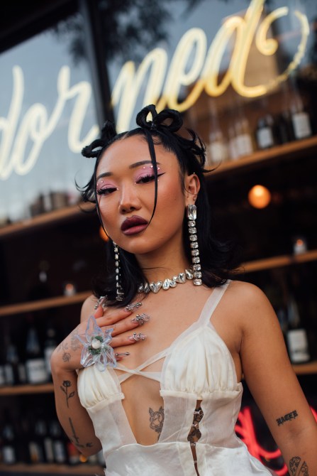 A fashion week guest wearing dangly earrings.