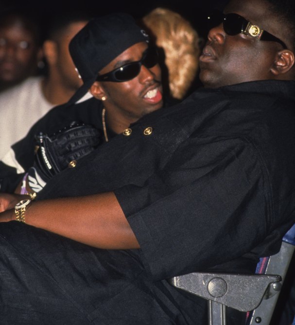 NEW YORK - AUGUST 3:  Rappers The Notorious B.I.G. aka Biggie Smalls (Christoper Wallace) and Puff Daddy (Sean Combs) take in Dr. Dre's performance at the second Source Awards at the Palladium on August 3, 1995 in New York, New York
