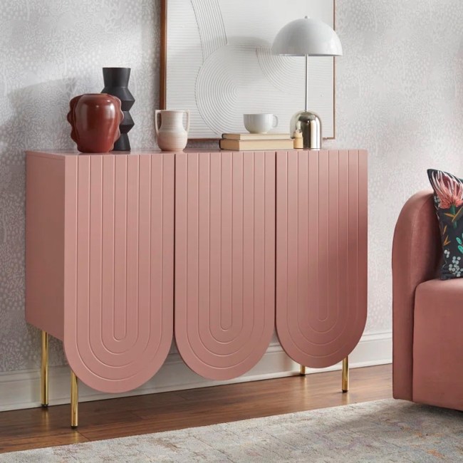 A pink sideboard in a living room