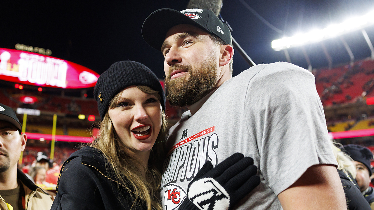 KANSAS CITY, MISSOURI - JANUARY 26: Tight end Travis Kelce #87 of the Kansas City Chiefs celebrates with Taylor Swift after the AFC Championship football game against the Buffalo Bills, at GEHA Field at Arrowhead Stadium on January 26, 2025 in Kansas City, Missouri.