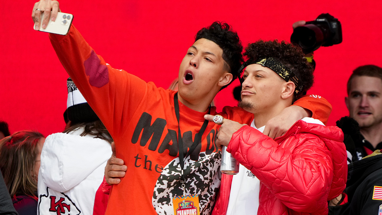 KANSAS CITY, MISSOURI - FEBRUARY 15: Jackson Mahomes and Patrick Mahomes #15 of the Kansas City Chiefs celebrate on stage during the Kansas City Chiefs Super Bowl LVII victory parade on February 15, 2023 in Kansas City, Missouri.