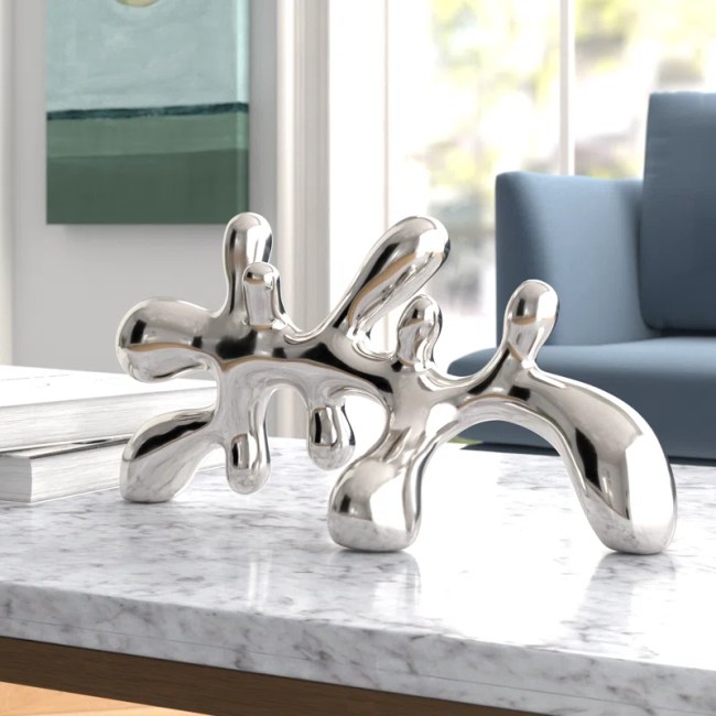 A silver, abstract figurine