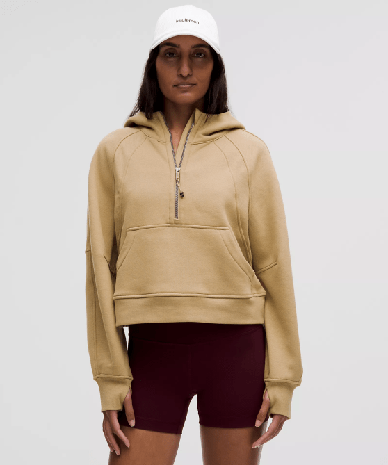 A model wearing the Lululemon Scuba Oversized Half-Zip Hoodie in a tan-camel colorway