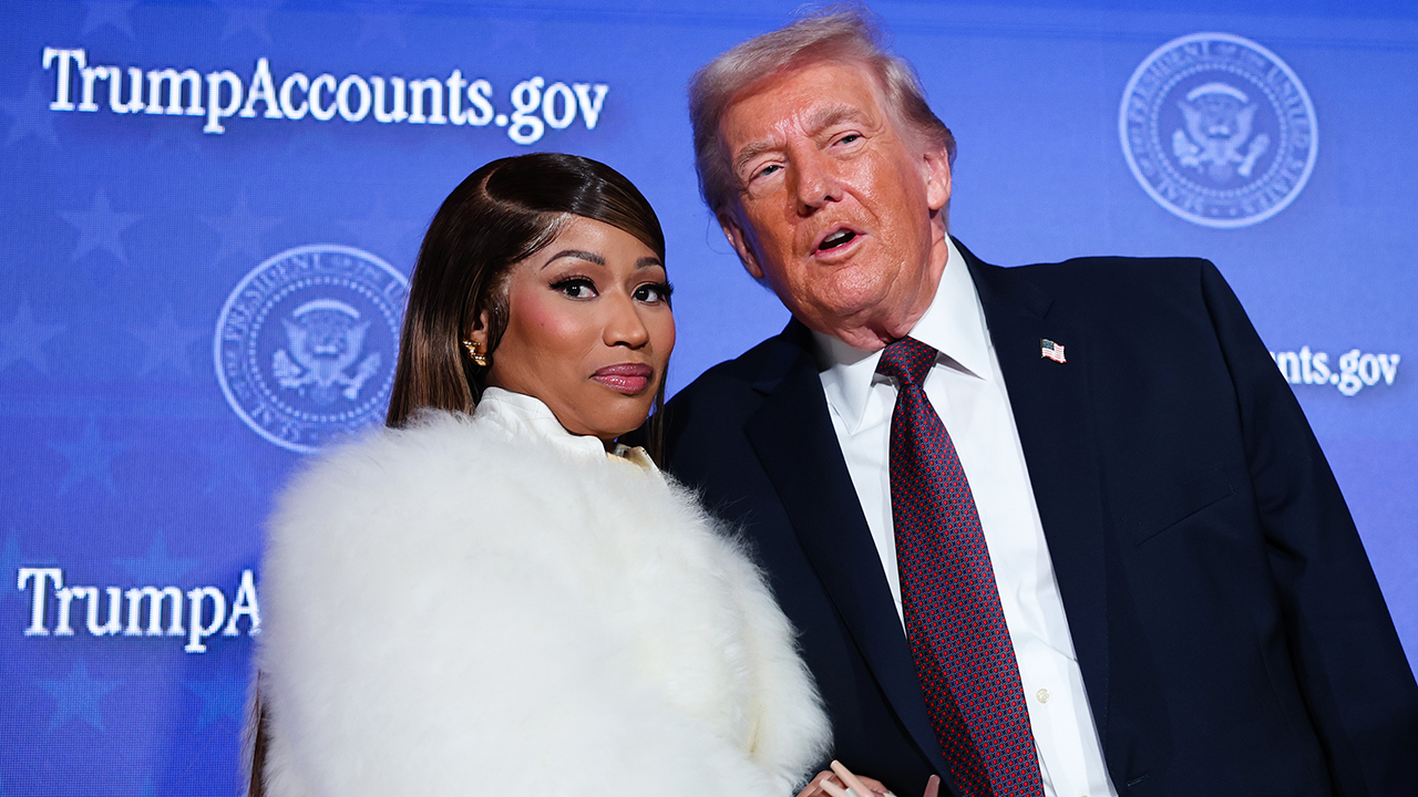 WASHINGTON, DC - JANUARY 28: Musician Nicki Minaj (L) joins U.S. President Donald Trump on stage as he delivers remarks during the Treasury Department's Trump Accounts Summit at Andrew W. Mellon Auditorium on January 28, 2026 in Washington, DC. "Trump Accounts" are a portion of recently passed tax and spending legislation where the federal government will deposit $1,000 into investment accounts for every child born between 2025 and 2028 once parents sign their children up while filing their income taxes.