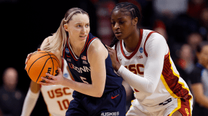 SPOKANE, WASHINGTON - MARCH 31: Paige Bueckers #5 of the UConn Huskies makes a move on Clarice Akunwafo #34 of the USC Trojans during the second half in the Elite Eight round of the NCAA Women's Basketball Tournament at Spokane Arena on March 31, 2025 in Spokane, Washington.