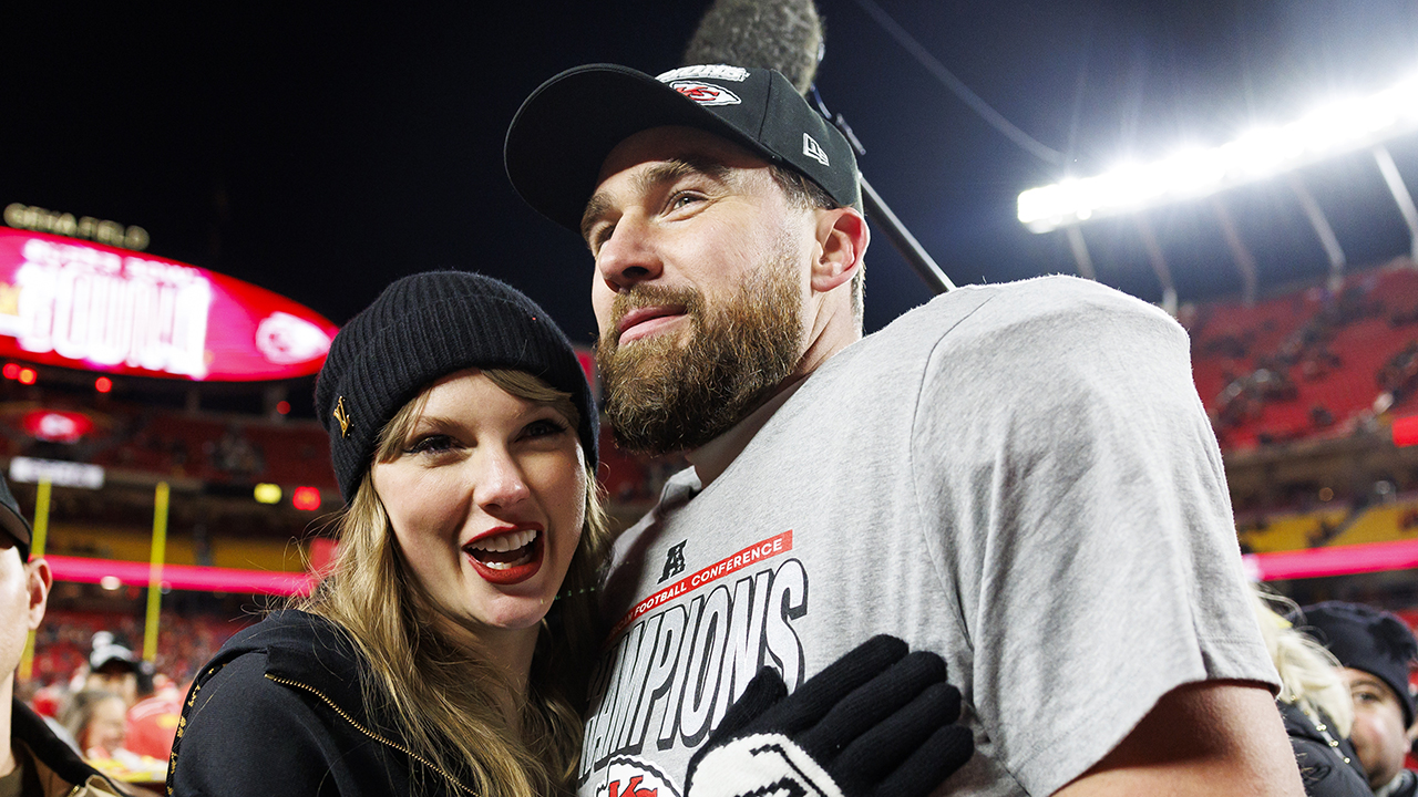 KANSAS CITY, MISSOURI - JANUARY 26: Tight end Travis Kelce #87 of the Kansas City Chiefs celebrates with Taylor Swift after the AFC Championship football game against the Buffalo Bills, at GEHA Field at Arrowhead Stadium on January 26, 2025 in Kansas City, Missouri.