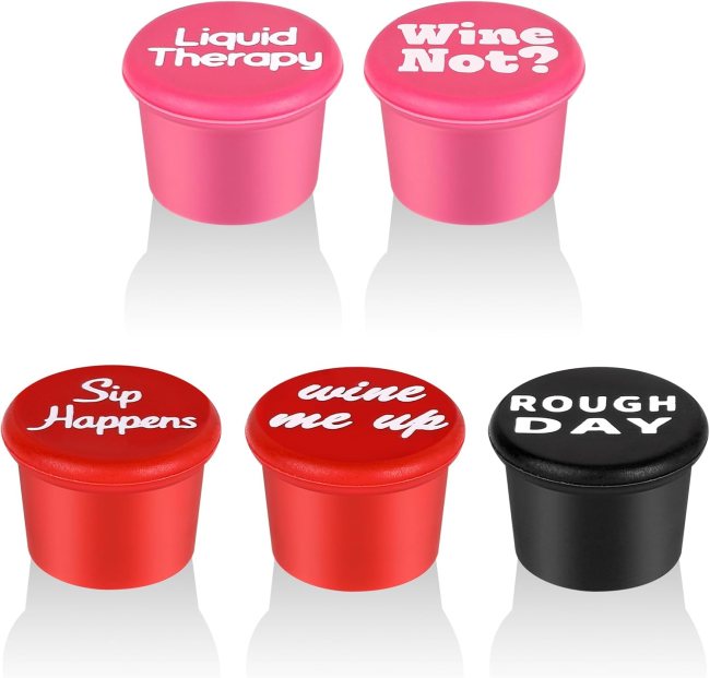 Five silicone wine stoppers in pink, red, and black