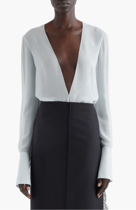 A model wearing the Givenchy Sheer Plunge Neck Long Sleeve Top in frost colorway
