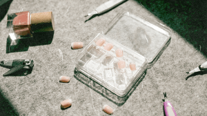 Press-on nails, a nail polish bottle, and nail tools.