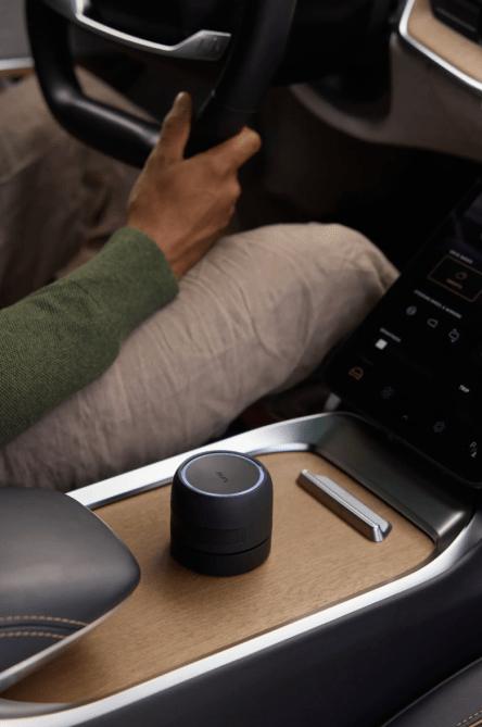 A Pura x Apotheke car diffuser sitting inside of a car