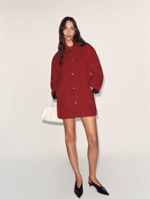 A model wearing Reformation's Irene Jacket in a lipstick red colorway