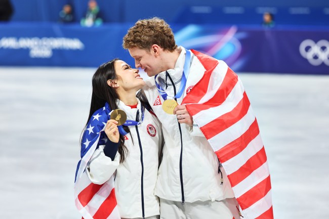 Gold medalists Madison Chock and Evan Bates of Team United States celebrate during the Medal Ceremony for the Team Event after the Men's Single Skating - Free Skating Team event on day two of the Milano Cortina 2026 Winter Olympics at Milano Ice Skating Arena on February 8, 2026 in Milan, Italy.